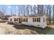 Ranch-style home with a brick facade, decorative shutters and a covered front porch at 4775 Barber Mill Rd, Clayton, NC 27520