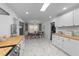 Open-concept kitchen with butcher block countertops, white cabinets, and an adjacent dining area, perfect for gatherings at 4775 Barber Mill Rd, Clayton, NC 27520