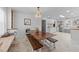 Bright kitchen with a large wooden table, chandelier, and white cabinets, offering a spacious and inviting atmosphere at 4775 Barber Mill Rd, Clayton, NC 27520