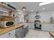 Modern kitchen equipped with stainless steel appliances, butcher block countertops, and open shelving for storage at 4775 Barber Mill Rd, Clayton, NC 27520