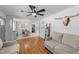 Bright living area transitions to dining space with neutral walls, ladder décor, and hardwood floors at 4775 Barber Mill Rd, Clayton, NC 27520