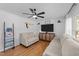 Comfortable living room with neutral colored couches, ceiling fan, hardwood flooring, and a mounted TV at 4775 Barber Mill Rd, Clayton, NC 27520