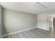 A bedroom features light wood flooring and freshly painted gray walls at 4807 Tyne Dr, Durham, NC 27703