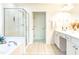 Bright bathroom with tiled floor, tub, separate glass enclosed shower, and vanity at 503 Gray Marble Rd, Morrisville, NC 27560