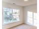 Bright bedroom featuring a large window with neighborhood views and neutral carpet at 503 Gray Marble Rd, Morrisville, NC 27560