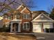 Charming brick two-story home featuring an attached two-car garage and manicured lawn at 503 Gray Marble Rd, Morrisville, NC 27560