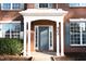 Close up of the front door on a charming brick home with white columns and blue door at 503 Gray Marble Rd, Morrisville, NC 27560