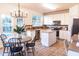 Eat in kitchen with an island, stainless steel appliances, and a stylish chandelier at 503 Gray Marble Rd, Morrisville, NC 27560