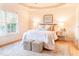 Bright main bedroom with tray ceilings, hardwood floors, and a large window at 503 Gray Marble Rd, Morrisville, NC 27560