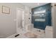 Bathroom with glass shower with white and blue tiling and bench seating at 5032 Big Creek Rd, Raleigh, NC 27613