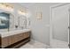 Bathroom with a double sink vanity, gold fixtures, and a glass enclosed shower at 5032 Big Creek Rd, Raleigh, NC 27613
