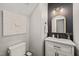 Stylish powder room with modern fixtures, marble countertop, and unique accent wall adds a touch of elegance at 5032 Big Creek Rd, Raleigh, NC 27613