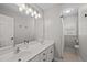 Bathroom features double sinks, large mirror, and a shower and toilet behind a half wall at 5032 Big Creek Rd, Raleigh, NC 27613