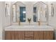 Bright bathroom features double sinks with gold fixtures and a glass shower door with blue tiling at 5032 Big Creek Rd, Raleigh, NC 27613