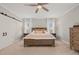 Inviting primary bedroom features a ceiling fan, natural light, and neutral tones for a relaxing atmosphere at 5032 Big Creek Rd, Raleigh, NC 27613