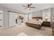 Inviting primary bedroom with a barn door closet, ceiling fan, and neutral tones for a relaxing atmosphere at 5032 Big Creek Rd, Raleigh, NC 27613