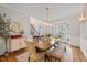 Bright dining room with a large window, stylish lighting and hardwood floors at 5032 Big Creek Rd, Raleigh, NC 27613