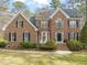 Charming brick home featuring manicured landscaping and a classic architectural design at 5032 Big Creek Rd, Raleigh, NC 27613