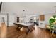 Spacious game room with hardwood floors, a pool table, and access to a home gym area at 5032 Big Creek Rd, Raleigh, NC 27613