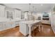 Bright, open kitchen features a large island with seating and lovely views into the home's living area at 5032 Big Creek Rd, Raleigh, NC 27613