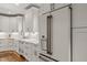 Bright, airy kitchen with stainless appliances and custom white cabinets offers ample storage and style at 5032 Big Creek Rd, Raleigh, NC 27613