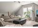 Inviting living room with vaulted ceilings, a comfortable sectional, and many windows at 5032 Big Creek Rd, Raleigh, NC 27613