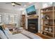 Cozy living room with a fireplace, built-in bookshelves, and comfortable seating at 5032 Big Creek Rd, Raleigh, NC 27613