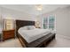 Bright bedroom with bed, bench, and window that brings in natural light at 5032 Big Creek Rd, Raleigh, NC 27613
