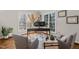 Sunlit home office featuring multiple windows, wood floors, and cozy seating at 5032 Big Creek Rd, Raleigh, NC 27613