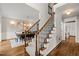 Inviting foyer with carpeted staircase and wood floors, leading to the upper level at 5032 Big Creek Rd, Raleigh, NC 27613