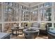 Cozy sunroom with plenty of natural light, a fire pit, and comfortable seating at 5032 Big Creek Rd, Raleigh, NC 27613