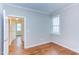 Bedroom featuring hardwood floors, base molding and neutral paint with view into hall at 604 Copperline Dr # 108, Chapel Hill, NC 27516