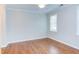 Spacious bedroom featuring gleaming hardwood floors, a ceiling fan, and a large window for natural light at 604 Copperline Dr # 108, Chapel Hill, NC 27516