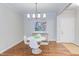 Stylish dining room with modern table, chairs, light fixture, and colorful art at 604 Copperline Dr # 108, Chapel Hill, NC 27516