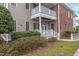 Townhome with a covered patio featuring white railings, neutral siding, and brick accents at 604 Copperline Dr # 108, Chapel Hill, NC 27516