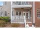 Charming covered patio featuring white railings, rocking chairs, and a ceiling fan at 604 Copperline Dr # 108, Chapel Hill, NC 27516