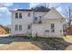 Backyard view of a two-story home with white siding and a large yard at 616 N Mebane St, Burlington, NC 27217