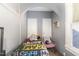 Small bedroom featuring two closet doors and a cute chair at 616 N Mebane St, Burlington, NC 27217