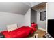 Small bedroom with red bedding and a tv box on the floor at 616 N Mebane St, Burlington, NC 27217