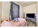 Bedroom featuring pink floral bedding and a covered window at 616 N Mebane St, Burlington, NC 27217