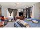 This bedroom includes a ceiling fan, 2 windows and a wooden dresser at 616 N Mebane St, Burlington, NC 27217