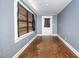 View of empty room with hardwood floors and access to other rooms at 616 N Mebane St, Burlington, NC 27217