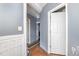 Hallway with classic paneling and doorway to other rooms, connecting the home at 616 N Mebane St, Burlington, NC 27217