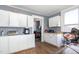 View of the kitchen with classic cabinets and a peek into the laundry area at 616 N Mebane St, Burlington, NC 27217