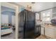 A compact kitchen with an adjacent view into a bedroom, and standard appliances at 616 N Mebane St, Burlington, NC 27217