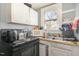 Simple kitchen space showcasing the oven, sink, window, and appliances at 616 N Mebane St, Burlington, NC 27217