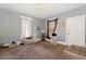 Spacious living room with carpet, window, and natural lighting at 616 N Mebane St, Burlington, NC 27217