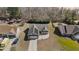 An aerial view of a single-Gathering home with a long driveway and solar panels in a lush green community at 66 Newbury Dr, Angier, NC 27501