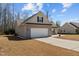 View of a single-story home with attached two-car garage and long driveway at 66 Newbury Dr, Angier, NC 27501