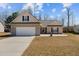 Charming single-story home featuring a two-car garage and manicured lawn at 66 Newbury Dr, Angier, NC 27501